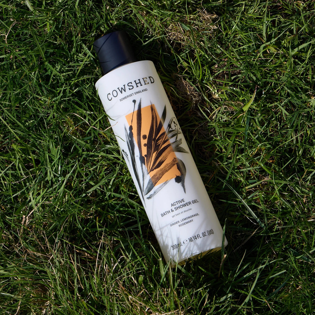 Cowshed Active 300ml shower gel on grass
