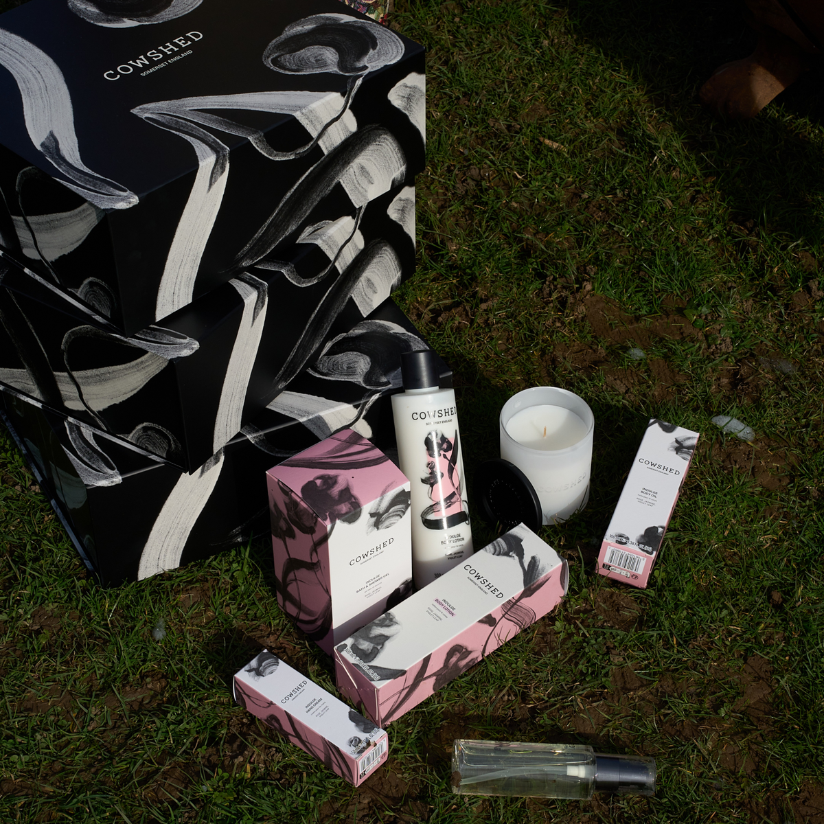 Cowshed Indulge product packaging on grass