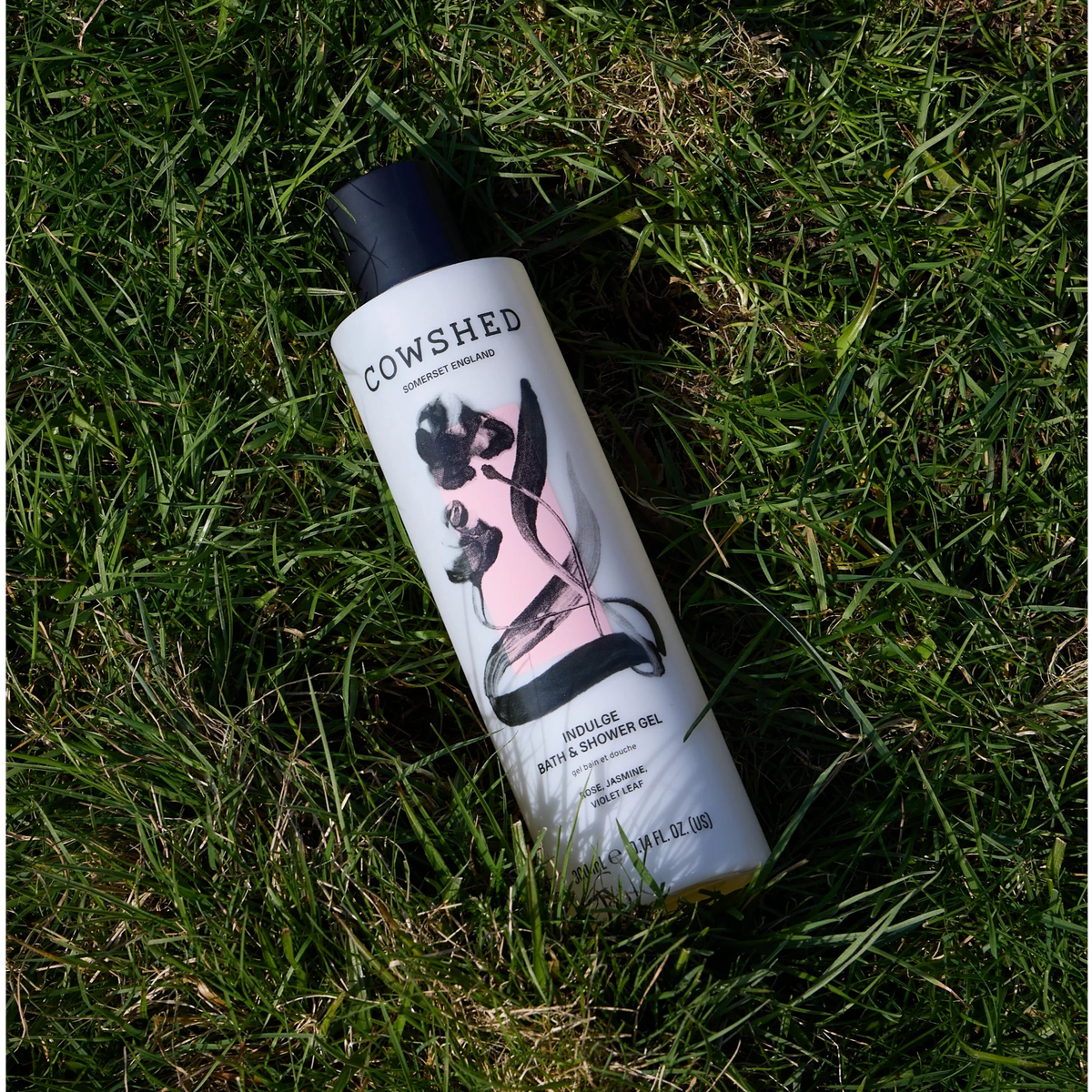 Cowshed Indulge bath and shower gel amongst grass