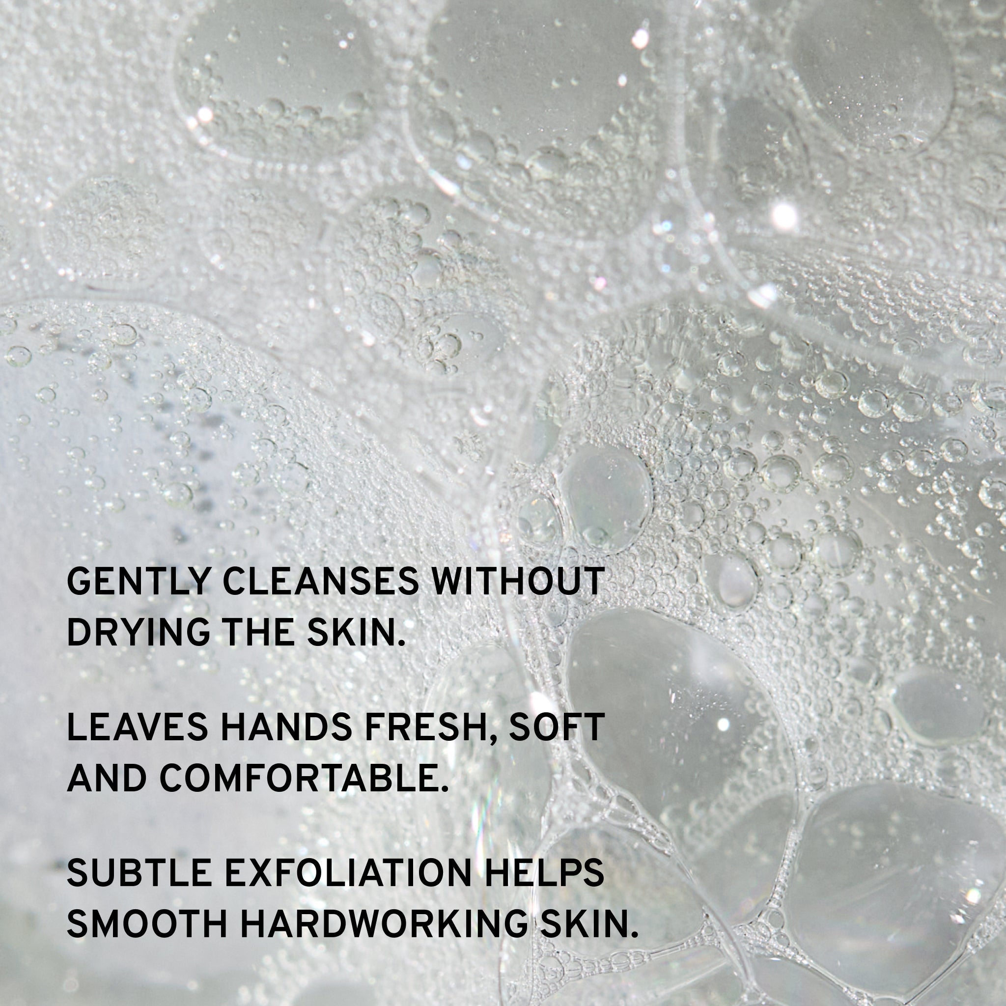 Close-up of soap bubbles with text about gentle exfoliation hand care benefits