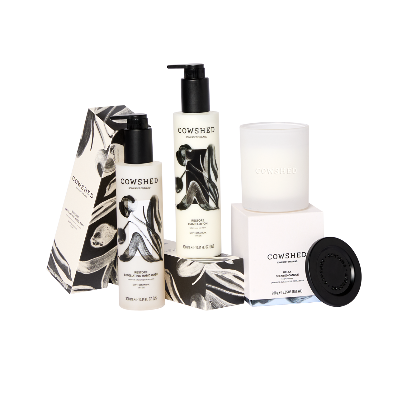 Cowshed skincare products including lotion, cream, and candle on a white background