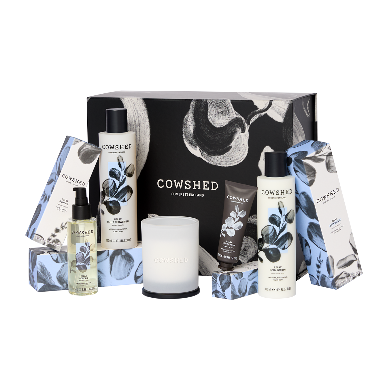 Cowshed product set with various items including bottles and a candle on a white background