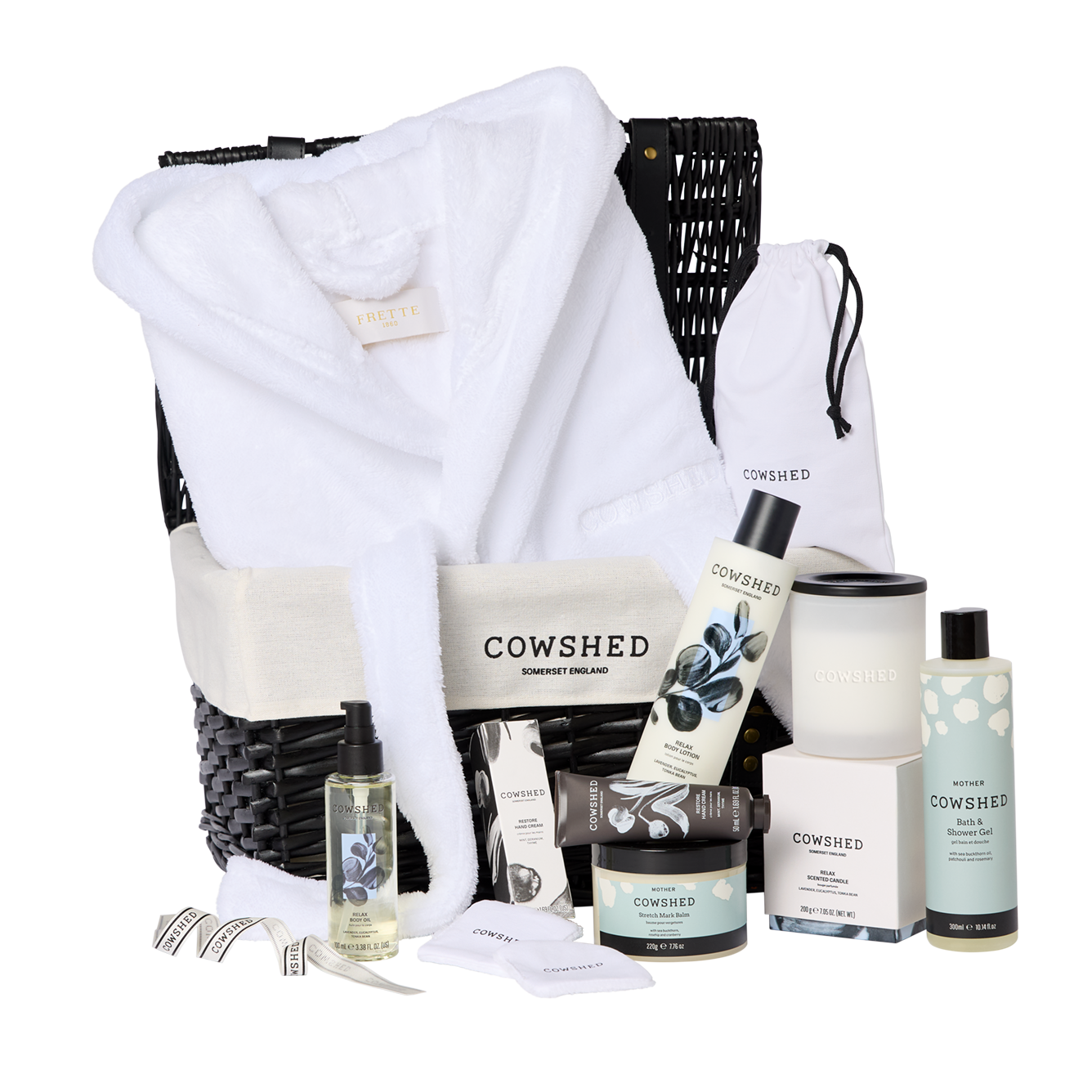 Cowshed product set with a robe and various skincare items on a white background