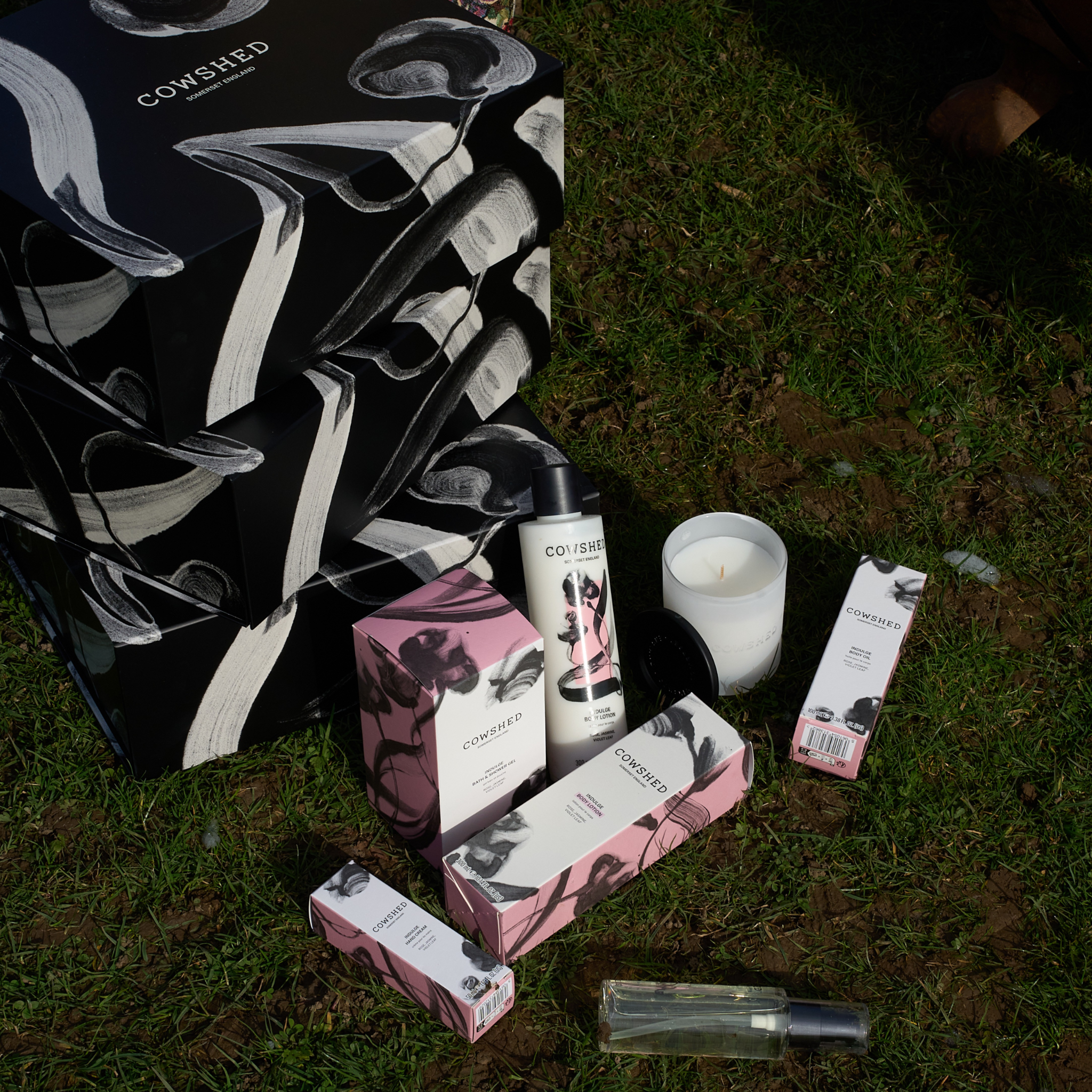Cowshed Indulge product packaging on grass