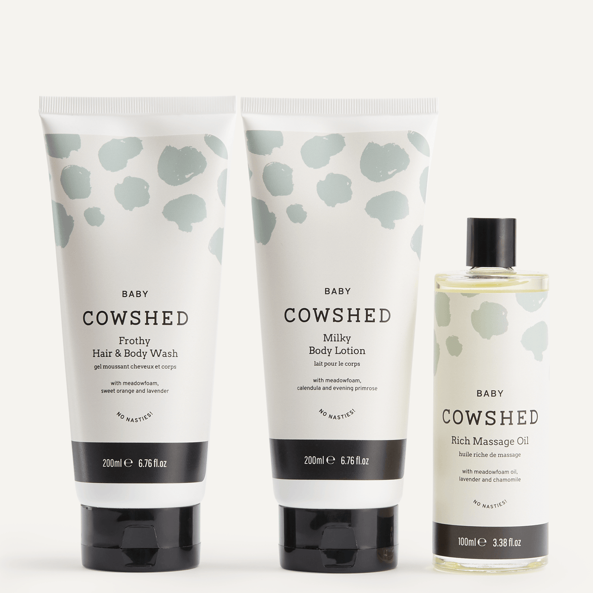 Cowshed baby skincare products including hair and body wash, lotion, and massage oil on a white background
