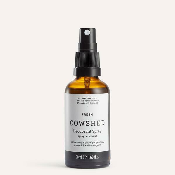 A bottle of Cowshed deodorant spray with a black spray nozzle. The label reads 'FRESH' and 'Cowshed Deodorant Spray'.